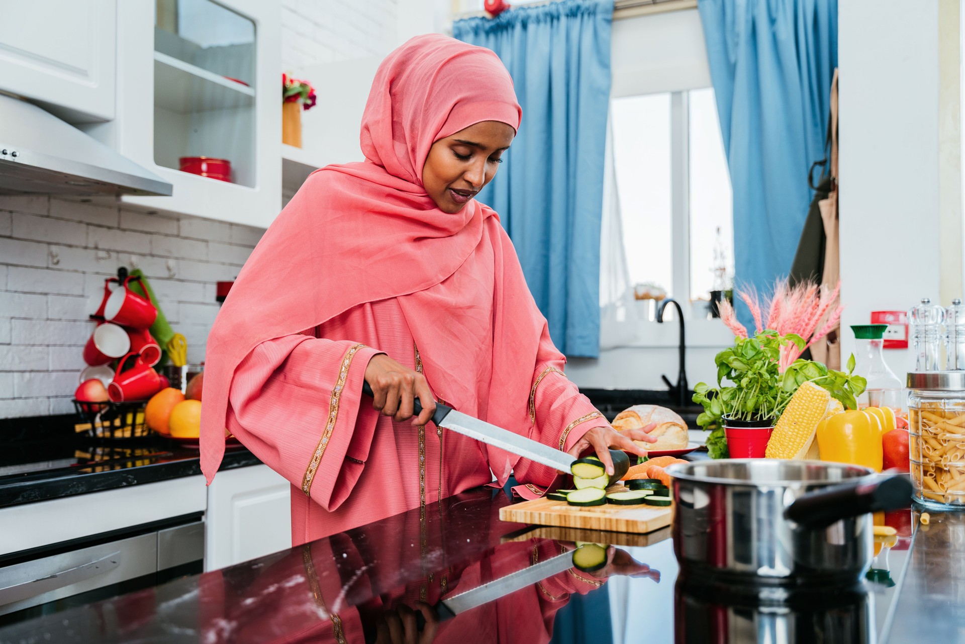 Happy and beautiful  middle eastern woman wearing traditional arab clothing at home